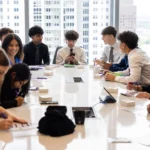 Students doing group exercise in office conference room