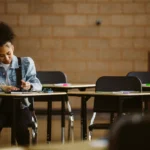 Female student writing at desk
